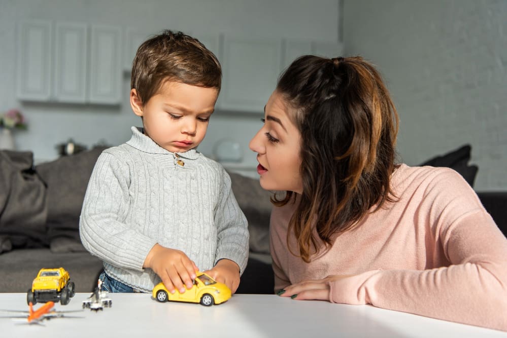 mother distracting toddler from tantrum