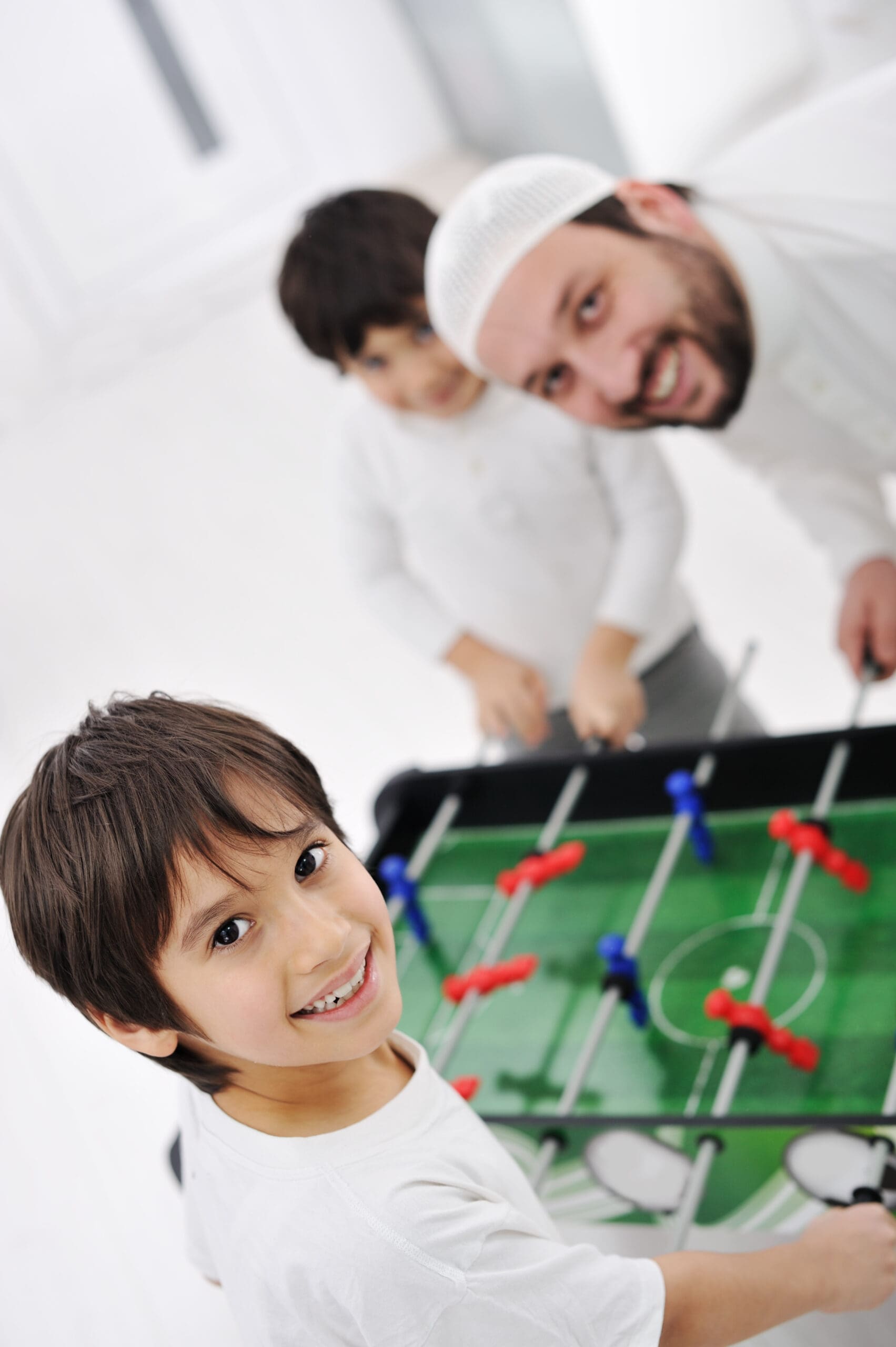 Father son playing foosball