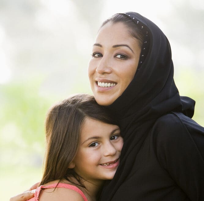 hijab mother hugging daughter